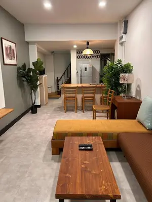 a living room with two couches and a table at Ni Haus, cozy place for 4 people in Bangkok