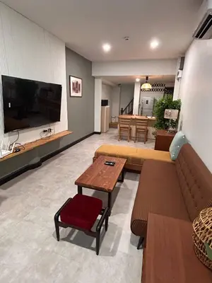 a living room with two couches and a tv at Ni Haus, cozy place for 4 people in Bangkok