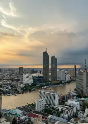 a view of a city with a river and buildings at Panoramic River View Residence in Bangkok