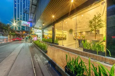 an empty street in a city at night at Ralph Poshtel Sukhumvit in Bangkok