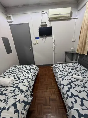 a room with a bed and a door in it at Ree House- Sukhumvit 23 in Bangkok