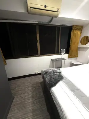 a room with a bed and some windows at Ree House- Sukhumvit 23 in Bangkok