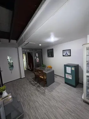 a room with a table and chairs in a room at Ree House- Sukhumvit 23 in Bangkok