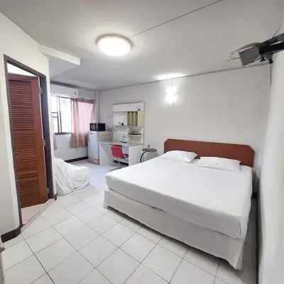 a bedroom with a large white bed in a room at BaanSathorn21 in Bangkok