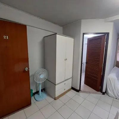 a room with a bedroom with a closet and a fan at BaanSathorn21 in Bangkok