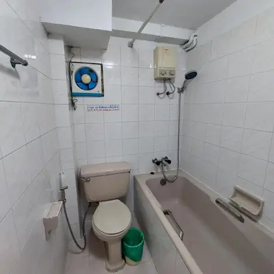 a bathroom with a toilet and a bath tub at BaanSathorn21 in Bangkok