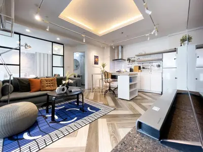 a living room with a couch and a table at Prime Chidlom 50sqm l Large Kitchen l Walk to BTS l Wifi in Bangkok