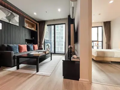 a living room with a bed and a couch at Near MRT l Modern 2BR l Pool and Gym l Sontana in Bangkok