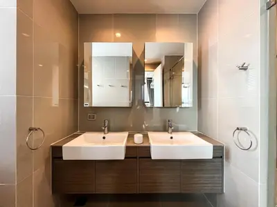 two sinks in a bathroom with two mirrors at Near MRT l Modern 2BR l Pool and Gym l Sontana in Bangkok