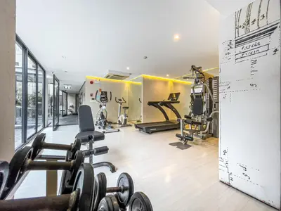 a gym with several treadmills and exercise machines at Prime Sukhumvit Living - BTS Phrom Phong - Ultra Fast WiFi in Bangkok