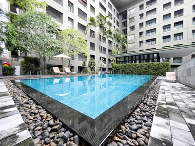 a swimming pool in the middle of a building at Prime Sukhumvit Living - BTS Phrom Phong - Ultra Fast WiFi in Bangkok