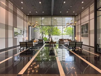 a living room with a glass table and chairs at Asoke Luxury High Rise - Steps to BTS and MRT - WiFi in Bangkok