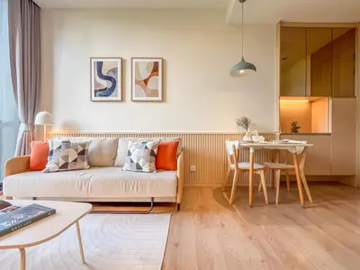 a living room with a couch and a table at Asoke Luxury High Rise - Steps to BTS and MRT - WiFi in Bangkok