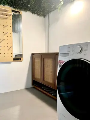 a washing machine in a room with a cabinet at Thong Lo 3BR Home 75in SmartTV Netflix - Quiet Home in the City Center in Bangkok