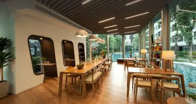 a restaurant with tables and chairs and a pool at Elio Sukhumvit 64 BTS Punnawithi in Amphoe Phra Khanong