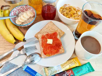a plate of toast with jelly and a cup of coffee at HOLY SHEET Hostel in Bangkok