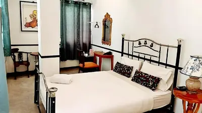 a bedroom with a bed with white sheets and pillows at XX The Character Yaowarat-ตรอกข้าวสาร in Samphanthawong