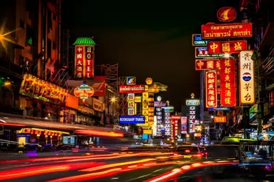 a busy city street at night with neon signs at XX The Character Yaowarat-ตรอกข้าวสาร in Samphanthawong