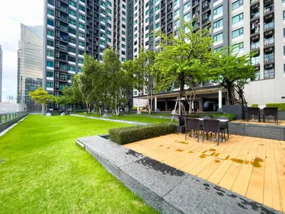 a park with a table and chairs and grass at 150 m to MRT l Workspace and Kitchen l Suana l Sontana in Bangkok