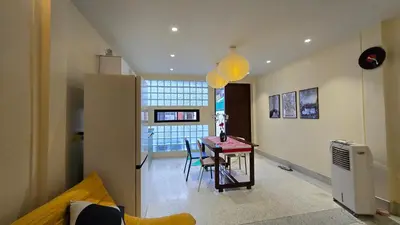 a living room with a table and chairs in a room at TownHouse near Central Ladprao with bathtub in Bangkok