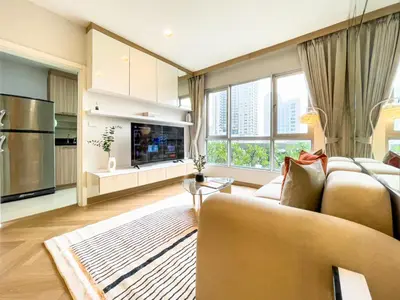 a living room with a couch and a large window at Elegant Stay near IconSiam l High-speed WiFi l BTS Wongwian Yai in Bangkok