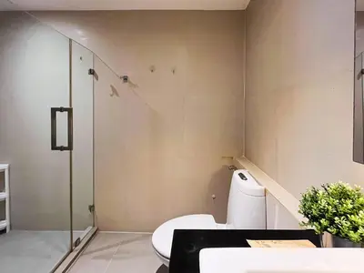 a bathroom with a toilet and a glass shower at Vibe Sukhumvit 61 l Ultra WIFI l Walk to BTS Thonglor or Ekkamai in Bangkok