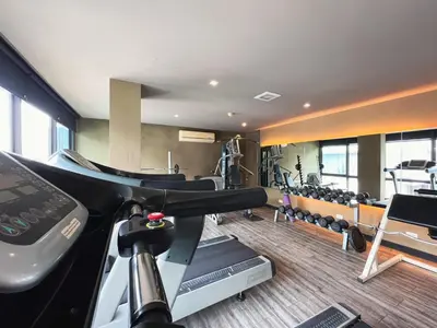 a fitness room with a gym with tread machines at Vibe Sukhumvit 61 l Ultra WIFI l Walk to BTS Thonglor or Ekkamai in Bangkok