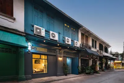 a blue building with speakers on the side of it at Large BTS 10 min 2King+Twin FastWiFi SelfCheckin in Bang Rak