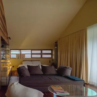 a living room with a couch and a glass table at Vanich House - Mechanic's Room in Bangkok