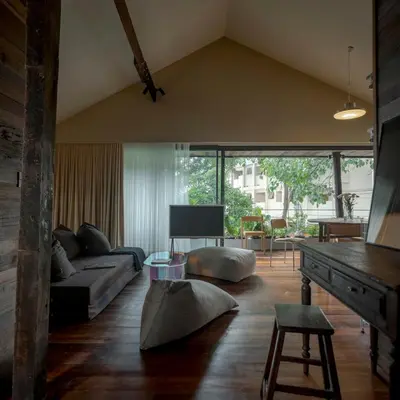 a living room with a couch and a table at Vanich House - Mechanic's Room in Bangkok