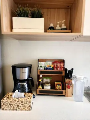 a kitchen counter with a coffee maker on a shelf at Cozy Bangkok Townhouse for 7 Guests, 5-Minute Walk from BTS in Amphoe Phra Khanong