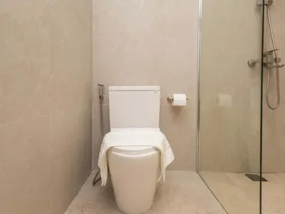 a bathroom with a toilet with a towel on it at 2 Bedrooms for 4 Guests with Terrace in the Heart of Sathorn in Bangkok