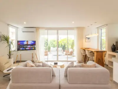 a living room with two white couches and a television at 2 Bedrooms for 4 Guests with Terrace in the Heart of Sathorn in Bangkok