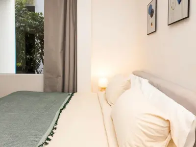 a white bed in a room with a window at 2 Bedrooms for 4 Guests with Kitchen at Heart of Sathorn in Bangkok