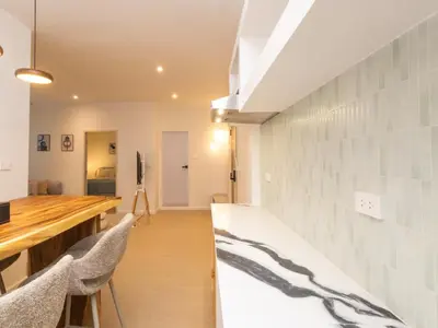 a room with a table and some chairs and a tablektop at 2 Bedrooms for 4 Guests with Kitchen at Heart of Sathorn in Bangkok