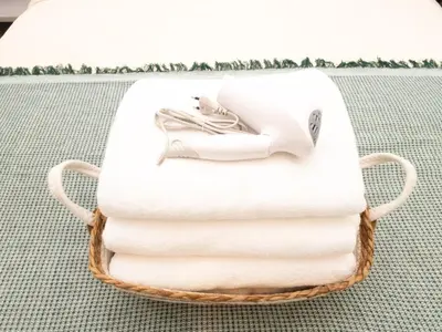 a basket of towels with a picture of a woman at 3 Bedroom for 6 Guests Family in the Heart of Sathorn in Bangkok