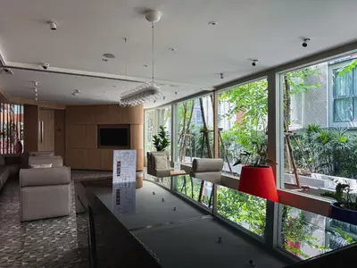 a lobby with a large room with a lot of windows at Near BTS l Workspace and Kitchen - Pool and Gym l Sontana in Bangkok