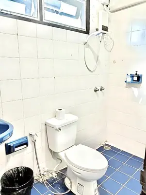 a bathroom with a toilet and a shower at x Mirt Inn Sukhumvit II - ถนนสุขุมวิท 2 in Bang Kapi