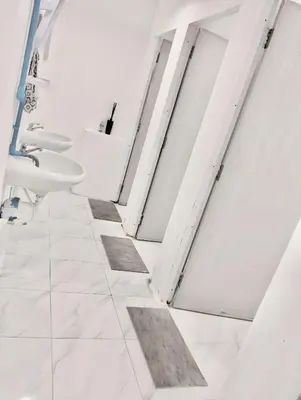 a bathroom with two sinks and two toilets at x Mirt Inn Sukhumvit II - ถนนสุขุมวิท 2 in Bang Kapi