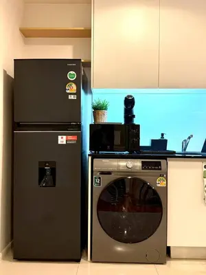 a kitchen with a microwave and a dishwasher at 3BD3BA Condo|City View|Hot Tub|7-11, PoolGym, Mall in Makkasan