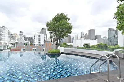 a swimming pool on the roof of a building with a city at 3BD3BA Condo|City View|Hot Tub|7-11, PoolGym, Mall in Makkasan