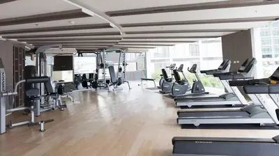 a gym with a bunch of treadmills and machines at 3BD3BA Condo|City View|Hot Tub|7-11, PoolGym, Mall in Makkasan
