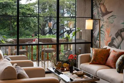 a living room with large windows and couches at Presidential Suite | 5 min BTS, Sun-Room| 159sqm in Khlong Toei