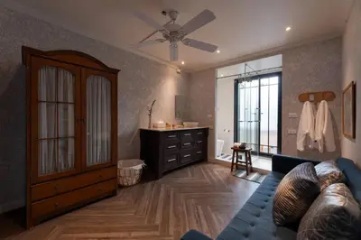 a living room with a couch and a ceiling fan at Presidential Suite | 5 min BTS, Sun-Room| 159sqm in Khlong Toei
