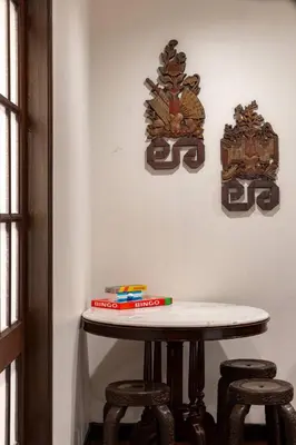 a table with three stools in a room at Chic 1BR |5 min BTS, 2 min to spa|500Mbps&bath-tub in Khlong Toei