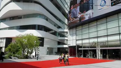 a group of people walking on a red carpet in front of a building at Chic 1BR |5 min BTS, 2 min to spa|500Mbps&bath-tub in Khlong Toei