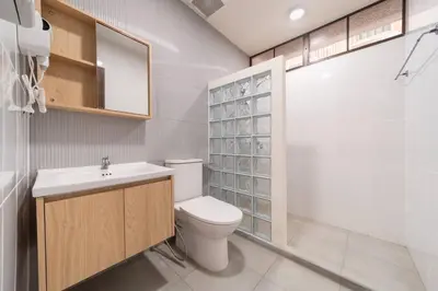 a bathroom with a toilet and a sink and a shower at ThongLor|Spacious 4BR4BA, Fast-WiFi, Netflix, Shop in Khlong Toei