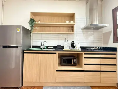 a kitchen with a stainless steel refrigerator and a microwave at Spacious CityCentre | 500 mbps, King-size, Balcony in Khlong Toei