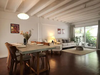a living room with a table and a couch at White House Ekkamai in Bangkok