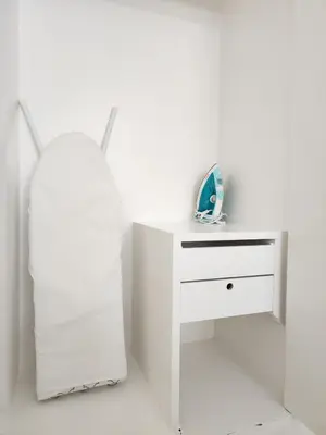 a white bedroom with a white desk and a mirror at White House Ekkamai in Bangkok